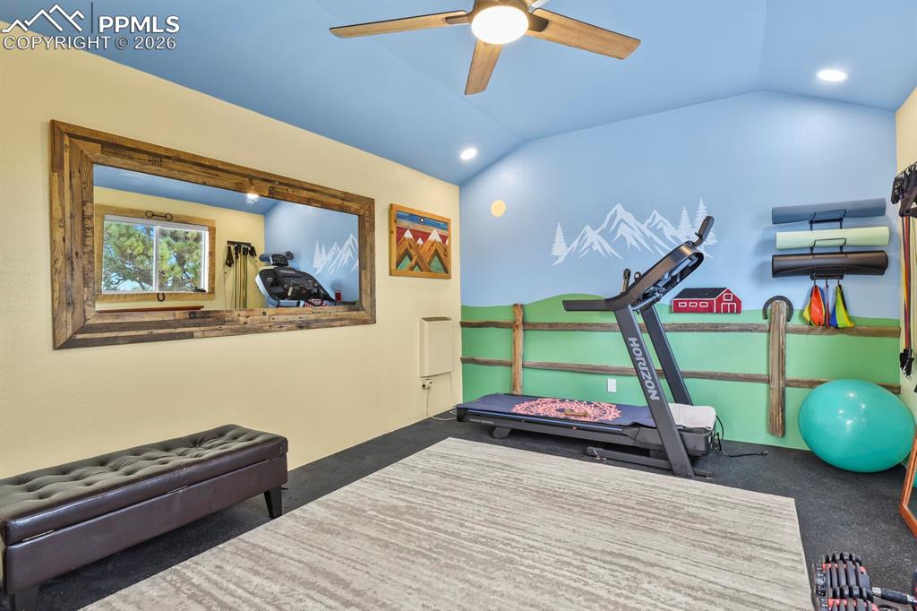 Image 33 of 41: Workout room featuring a ceiling fan, vaulted ceiling, and recessed lightin