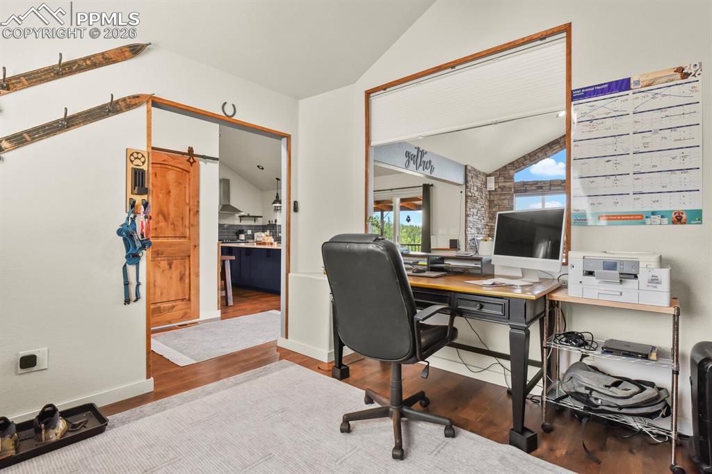 Image 5 of 41: Office featuring lofted ceiling, and wood finished floors