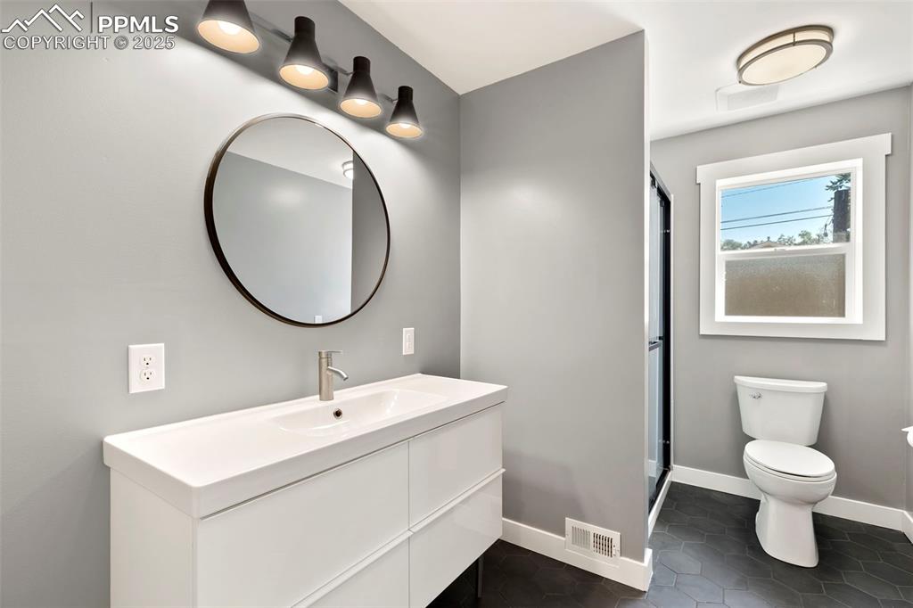 Image 23 of 48: Main level bath with stylish and character driven finishes