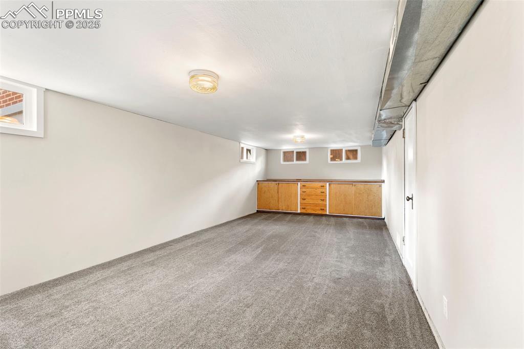 Image 33 of 48: Basement rec room with built ins!