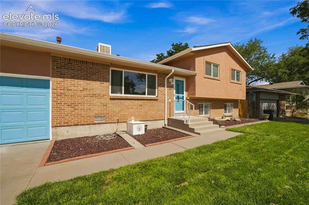 Image 33 of 39: Brick and stucco exterior with multiple windows
