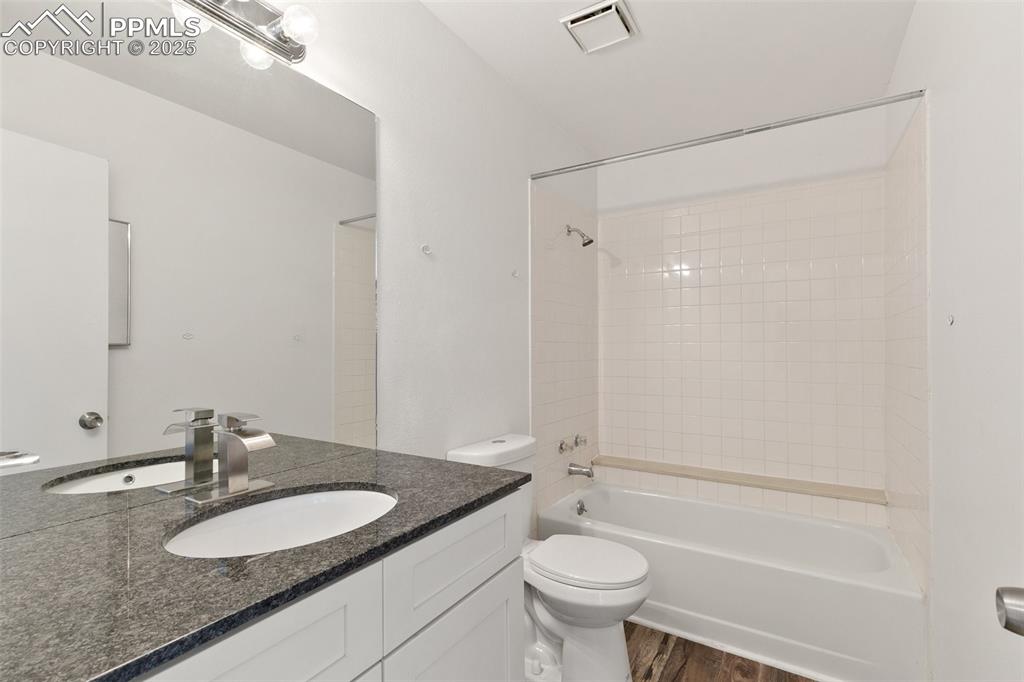 Image 16 of 33: Full bathroom featuring shower / bathtub combination, visible vents, toilet