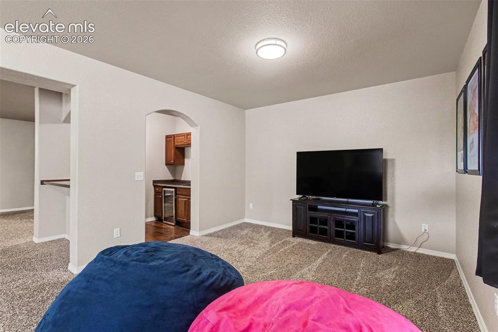 Image 28 of 47: Basement Family Room w/ Wet Bar