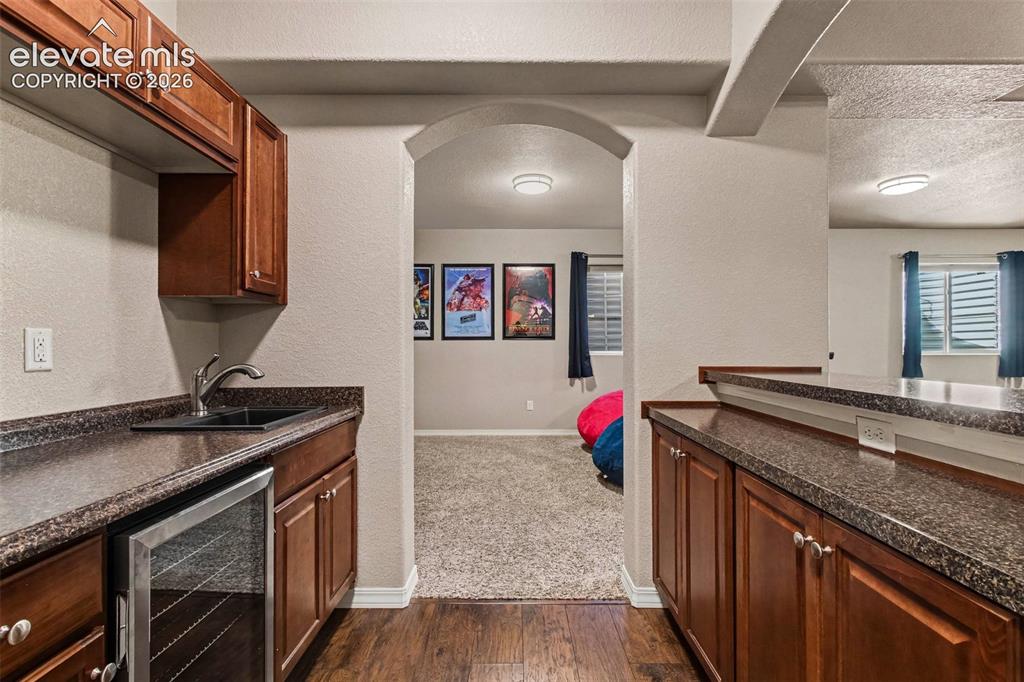 Image 30 of 47: Basement Wet Bar with Mini Fridge
