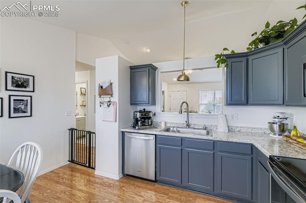 Image 10 of 28: Kitchen featuring stainless steel dishwasher, light wood-type flooring, han