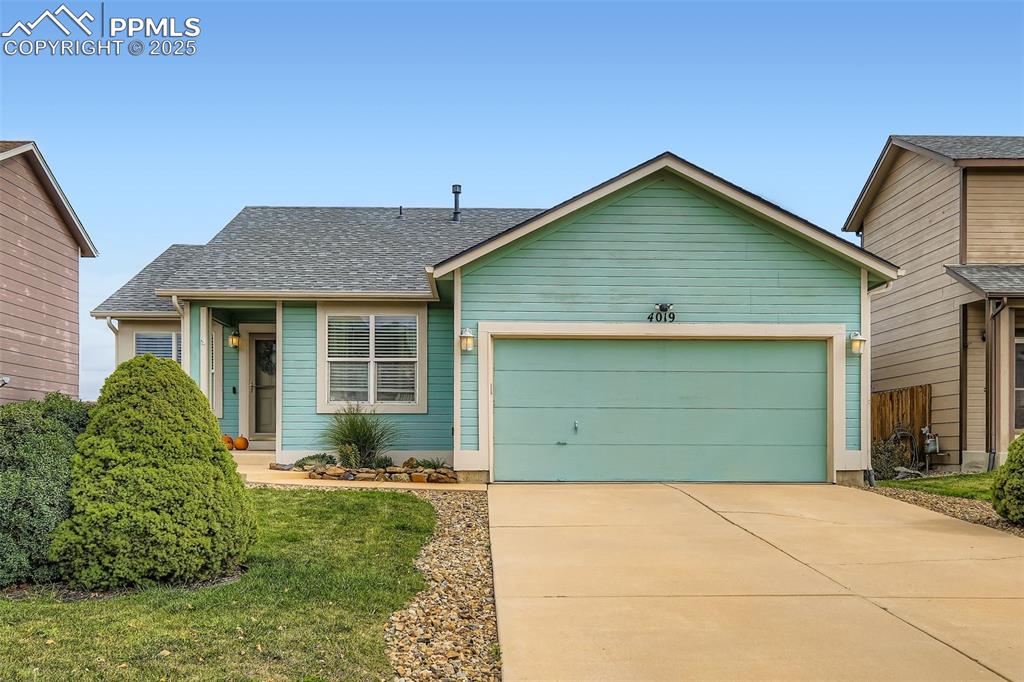 Image 2 of 28: View of front facade featuring roof with shingles, concrete driveway, a gar