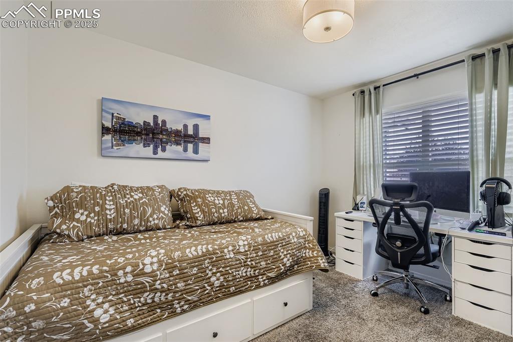 Image 23 of 28: Bedroom featuring carpet floors and an office area