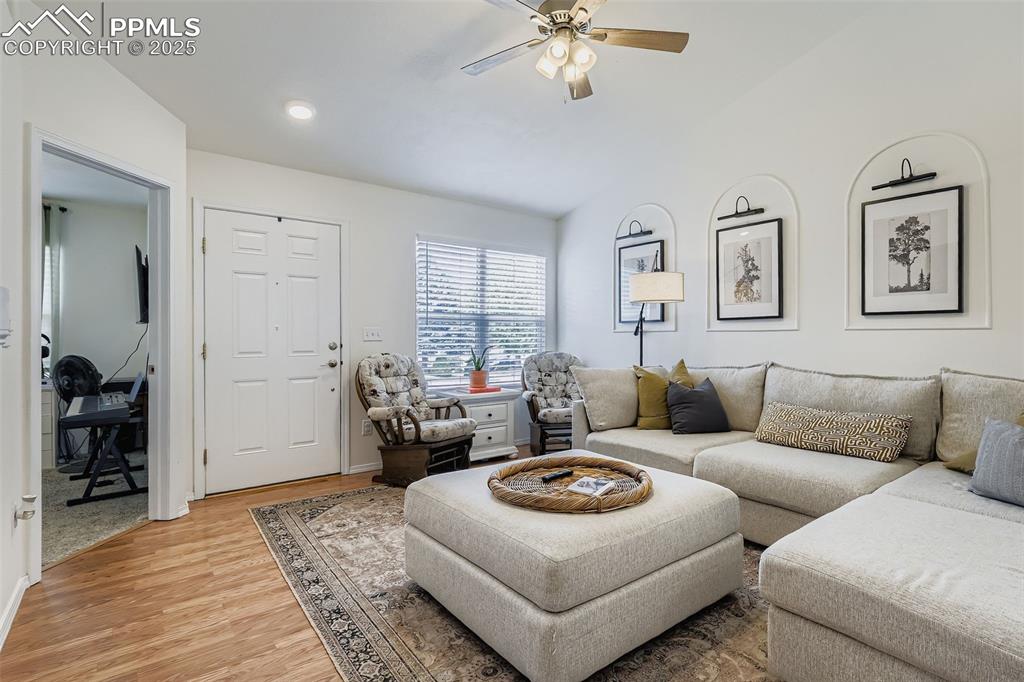 Image 7 of 28: Living area featuring light wood finished floors and ceiling fan