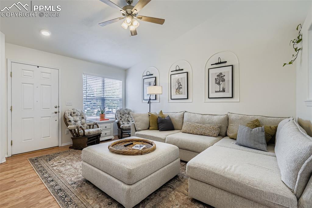 Image 8 of 28: Living area with wood finished floors, a ceiling fan, and recessed lighting