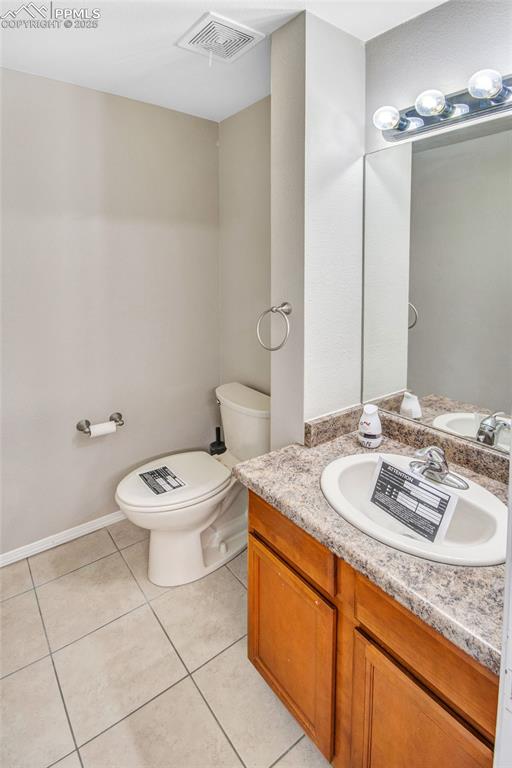 Image 19 of 35: Bathroom with light tile patterned flooring and vanity