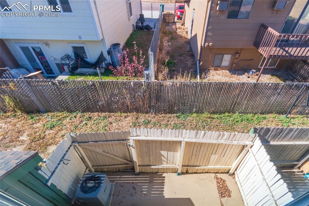 Image 8 of 35: Wooden terrace with a fenced backyard