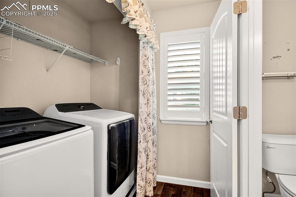 Image 10 of 37: Across the half bath is the laundry space with washer and dryer included