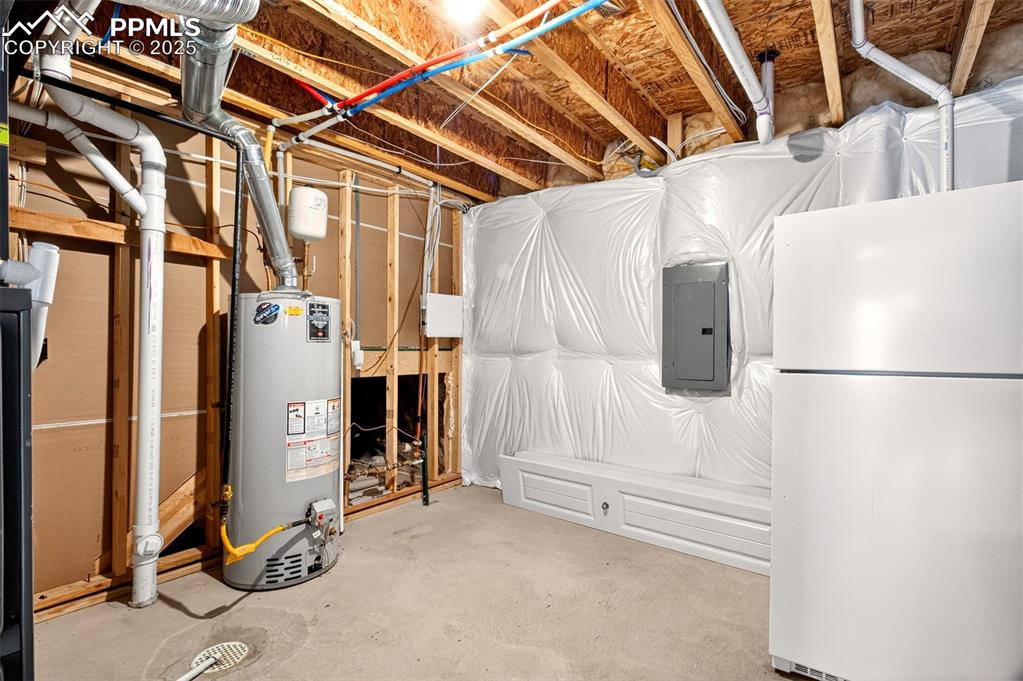 Image 31 of 37: Large utility room for storage, refrigerator included