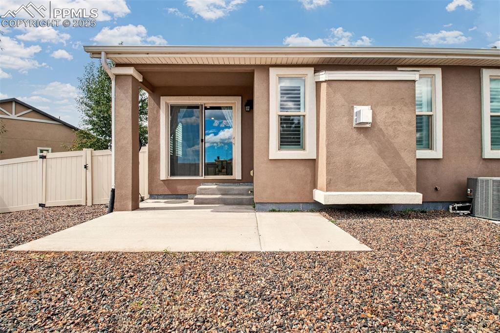 Image 32 of 37: Back patio has space for a table and chairs