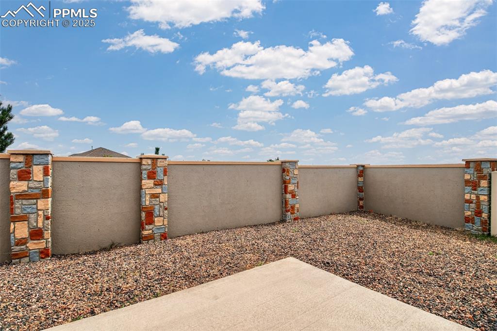 Image 34 of 37: Private back yard with a decorative back wall/fence