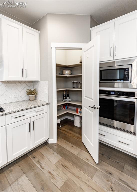 Image 13 of 37: Spacious walk-in pantry provides ample storage and keeps the kitchen organi