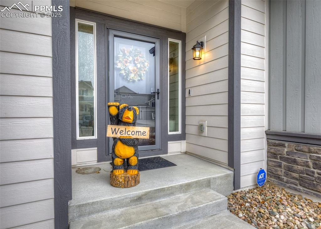 Image 2 of 37: The exterior entry features a welcoming covered front porch with attractive