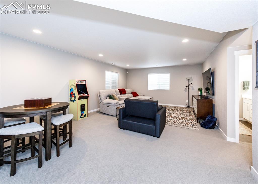 Image 24 of 37: Bright and roomy basement family room offers plenty of space for family act