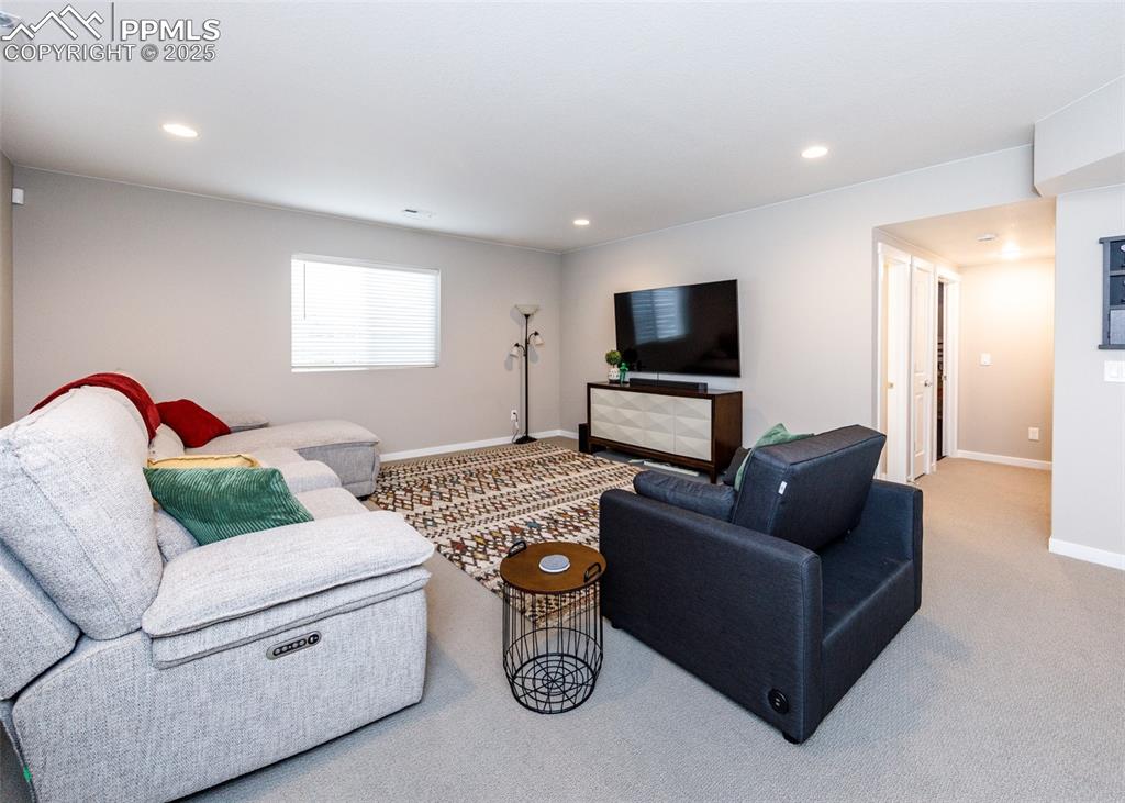 Image 25 of 37: Spacious family room located in the full basement, ideal for gatherings and