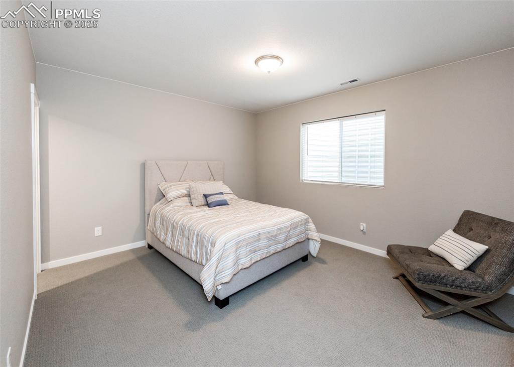 Image 26 of 37: Large basement bedroom offers ample space and flexibility for guests or hob