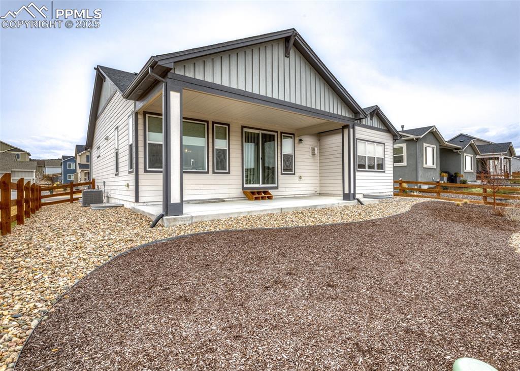 Image 30 of 37: Rear of the home with beautifully landscaped yard great for enjoying Colora