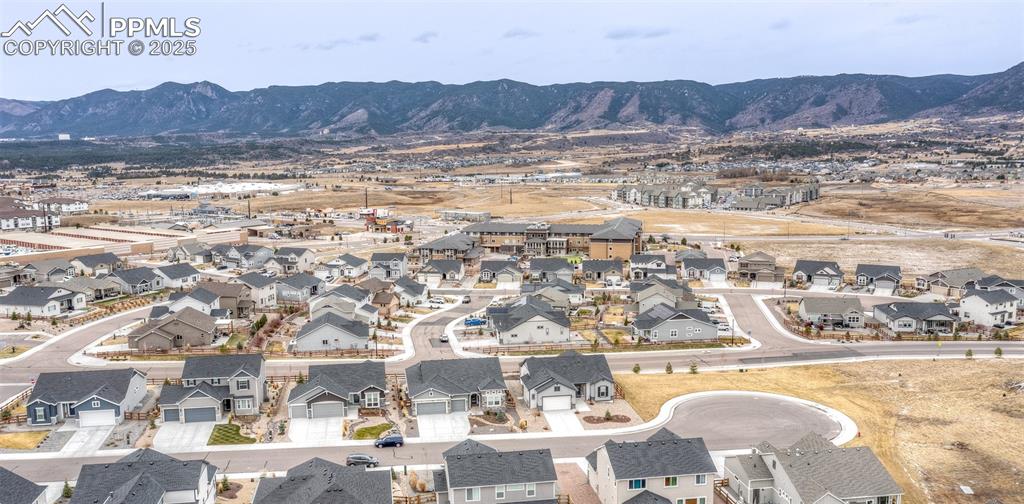 Image 37 of 37: Aerial view of residential area with mountains
