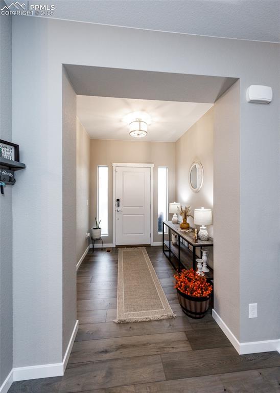 Image 4 of 37: Step into a bright, inviting foyer highlighted by rich hardwood-style floor