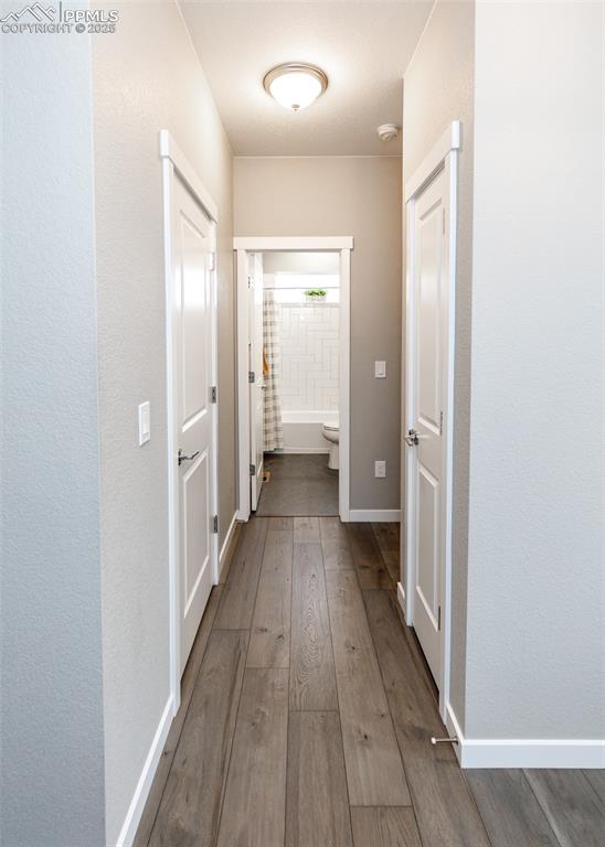 Image 5 of 37: A welcoming hallway guides you to a full bathroom and office, combining pra