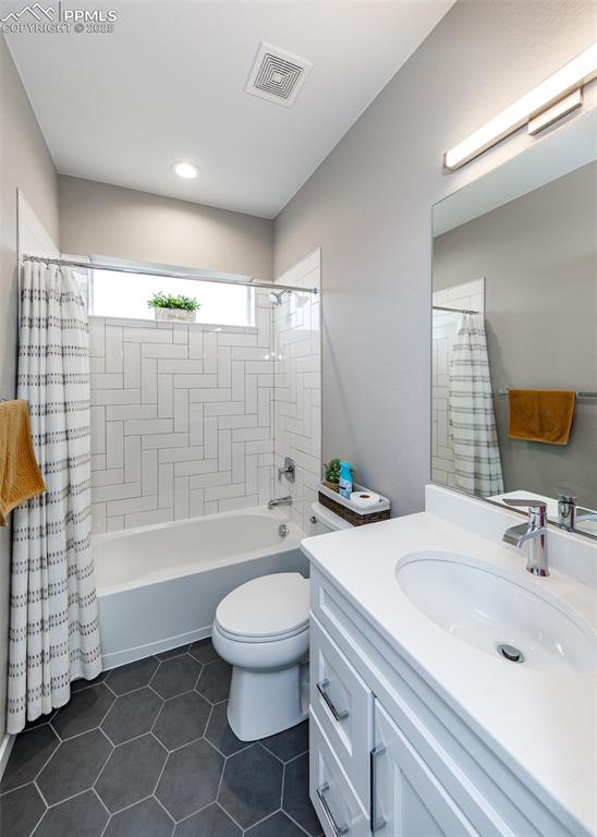 Image 6 of 37: Full bathroom with vanity and tub/shower