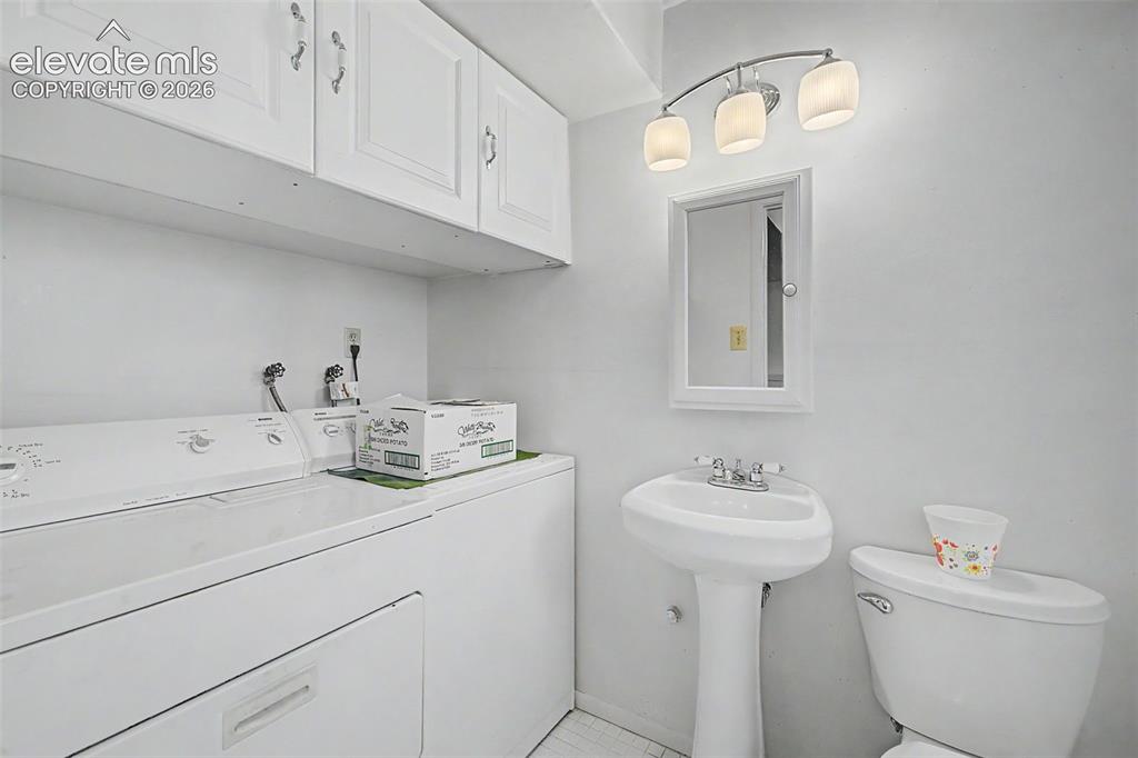 Image 23 of 50: Lower Bathroom with Laundry Room