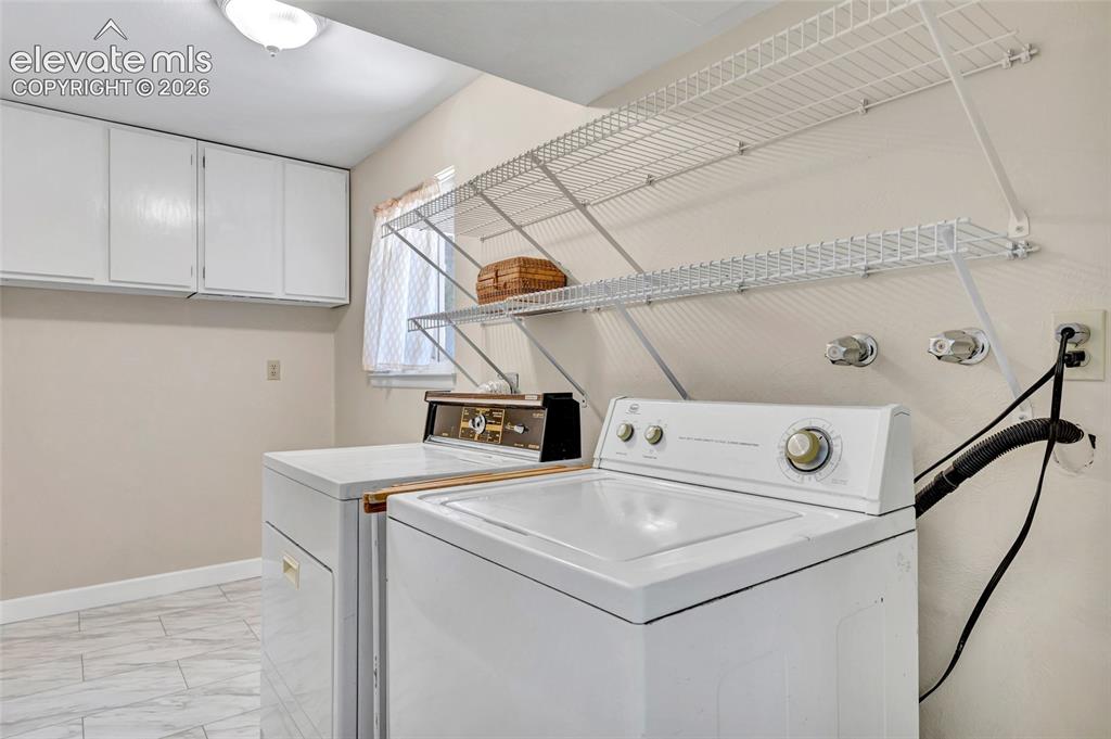 Image 11 of 26: Laundry room with laundry chute, and plenty of storage!