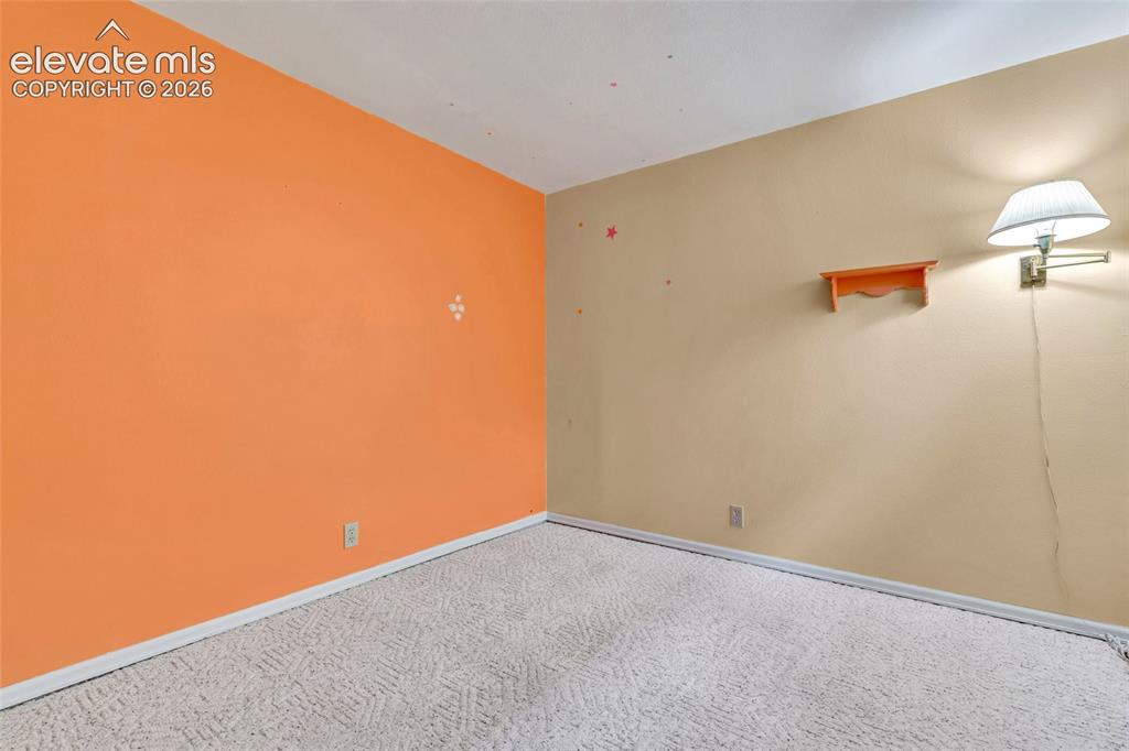Image 14 of 26: Bedroom 1 - 6-panel doors and carpet