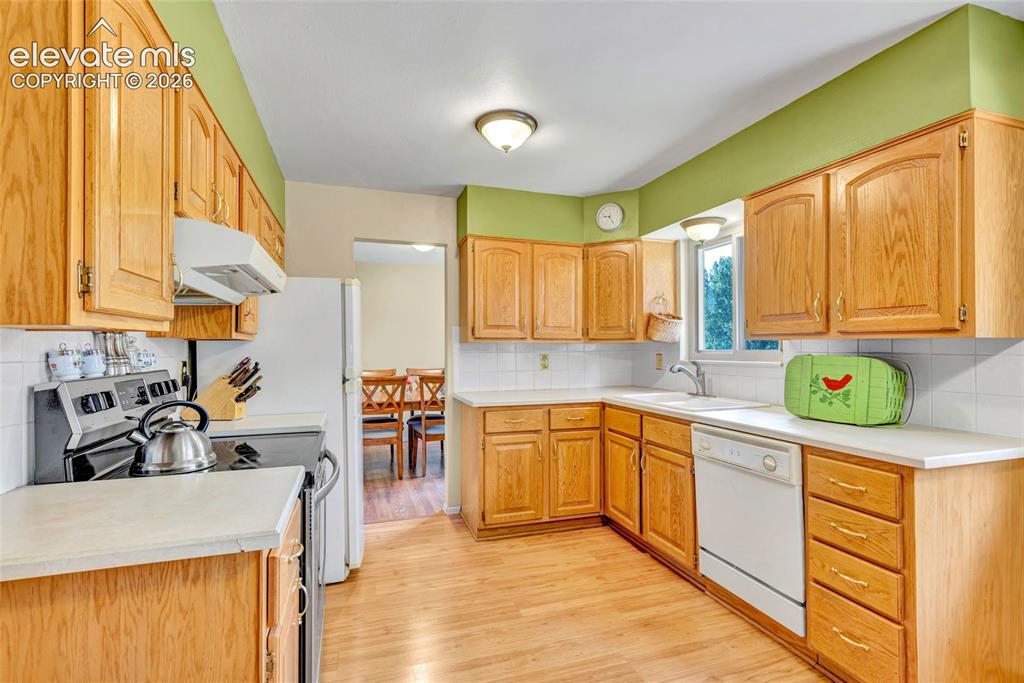 Image 2 of 26: Eat-in kitchen with views of the park and pass through to dining room