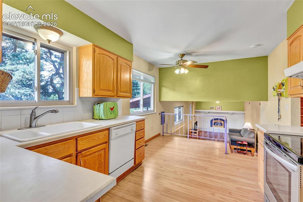 Image 8 of 26: Eat-in kitchen with views of the park and pass through to dining room