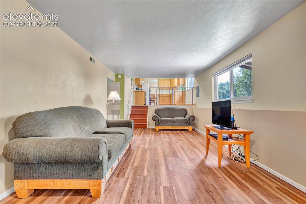 Image 9 of 26: Family room with fireplace and walkout to back patio