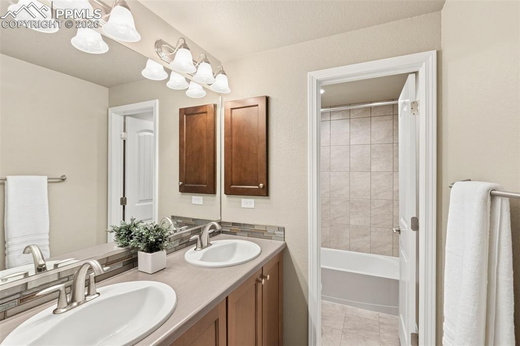 Image 32 of 43: Private shower and Toilet with dual vanities