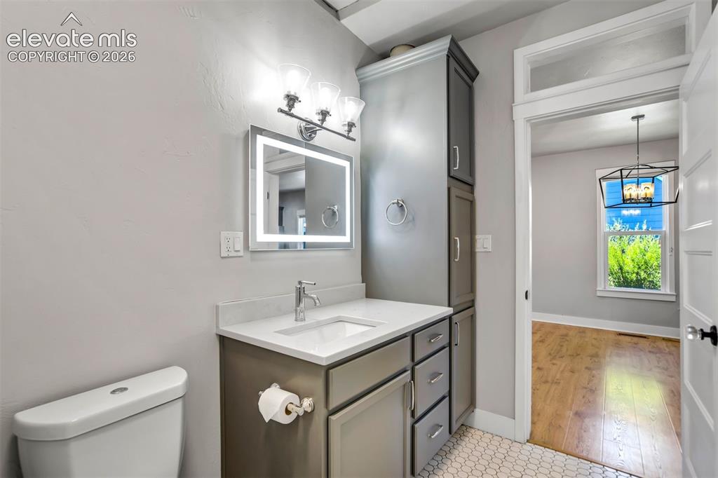 Image 17 of 50: Bathroom featuring a vanity with an integrated sink, quartz-finish countert