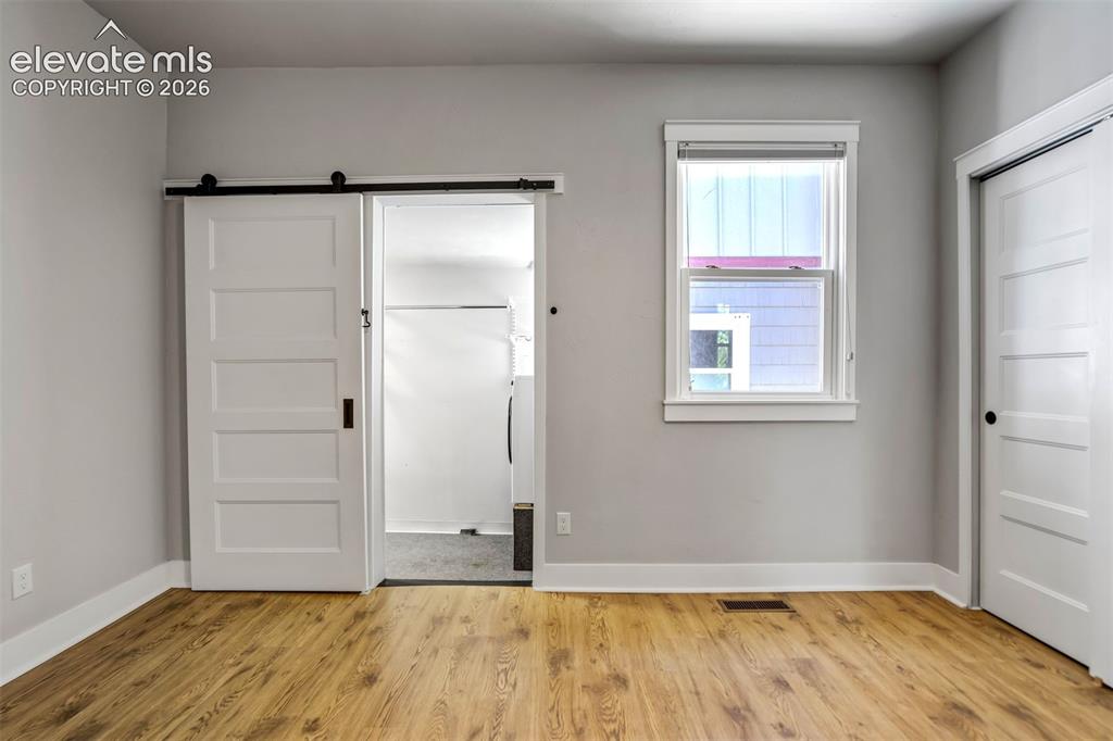 Image 20 of 50: Wood-finish flooring throughout
