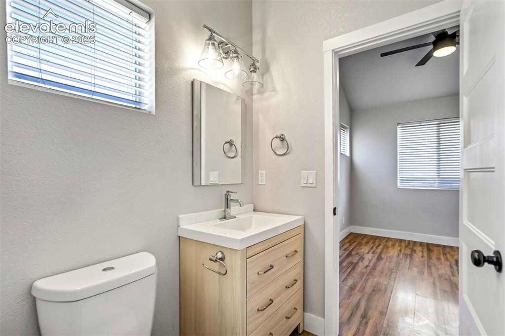 Image 40 of 50: Bathroom featuring a light wood-finish vanity with a white countertop and r
