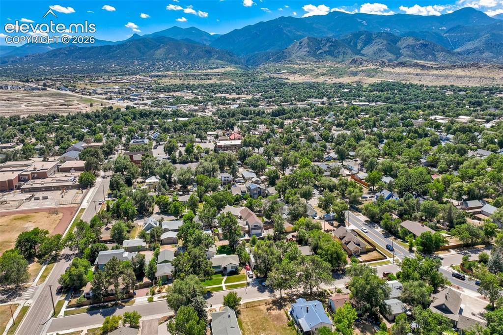 Image 48 of 50: Expansive neighborhood with abundant mature trees and distant mountain rang