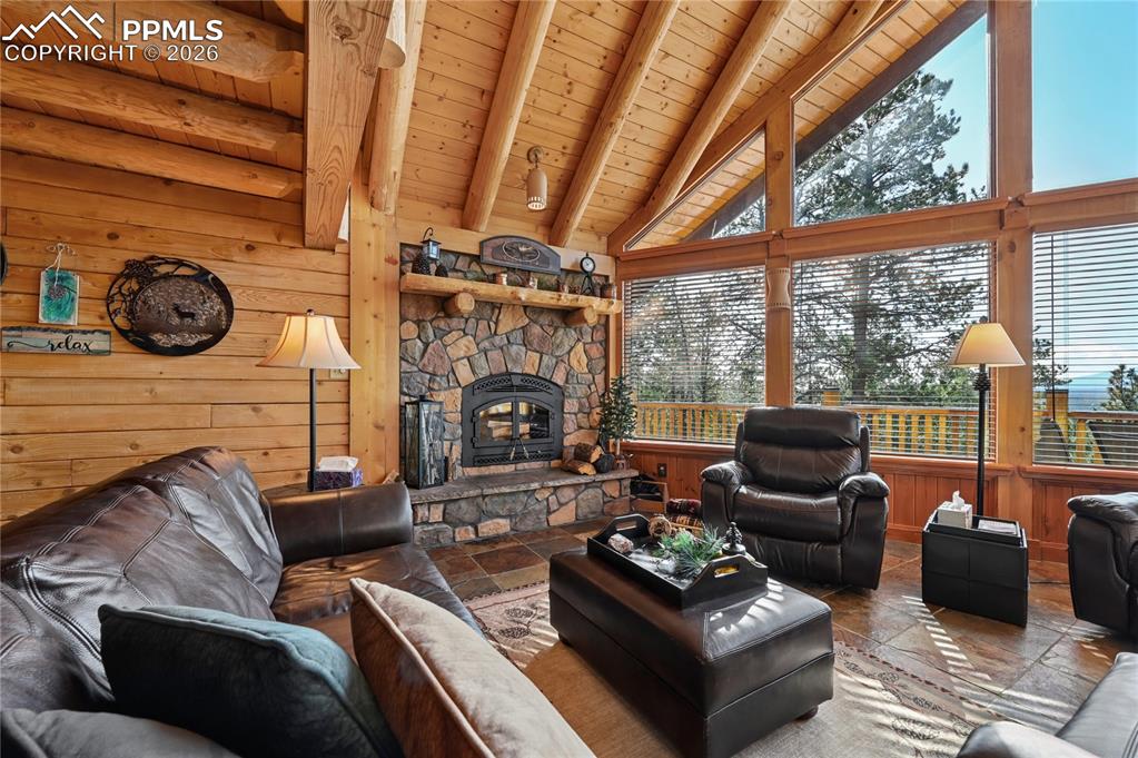 Image 12 of 43: The living room is warmed by one of 3 fireplaces, and this one is wood-burn
