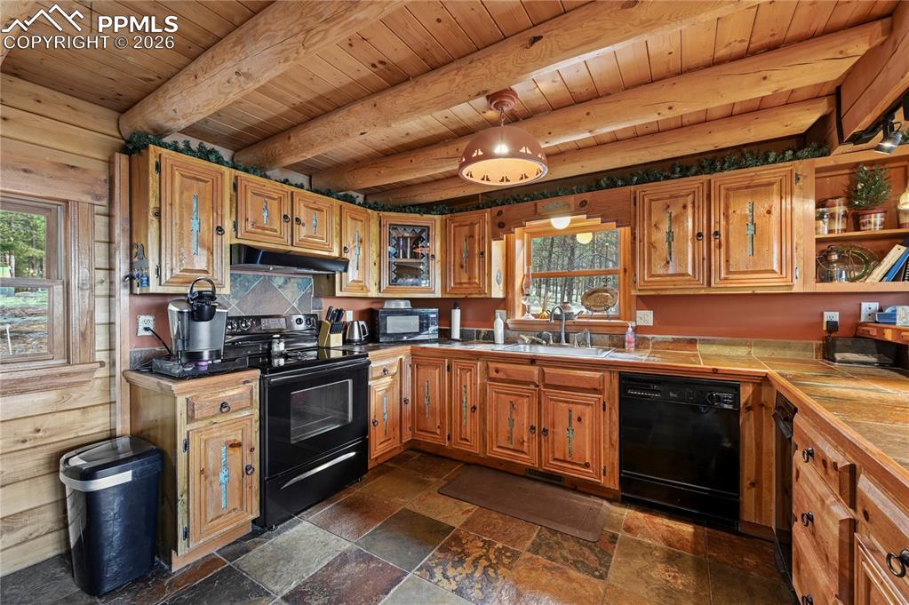 Image 16 of 43: This cozy kitchen continues the rustic, natural theme, and you