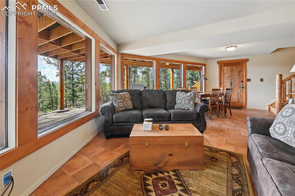 Image 32 of 43: The walk-out basement family room has enough space for another table & chai