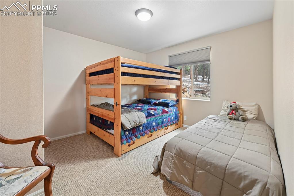 Image 34 of 43: Bedroom #4 of 5 is in the back of the basement, but still has above-ground
