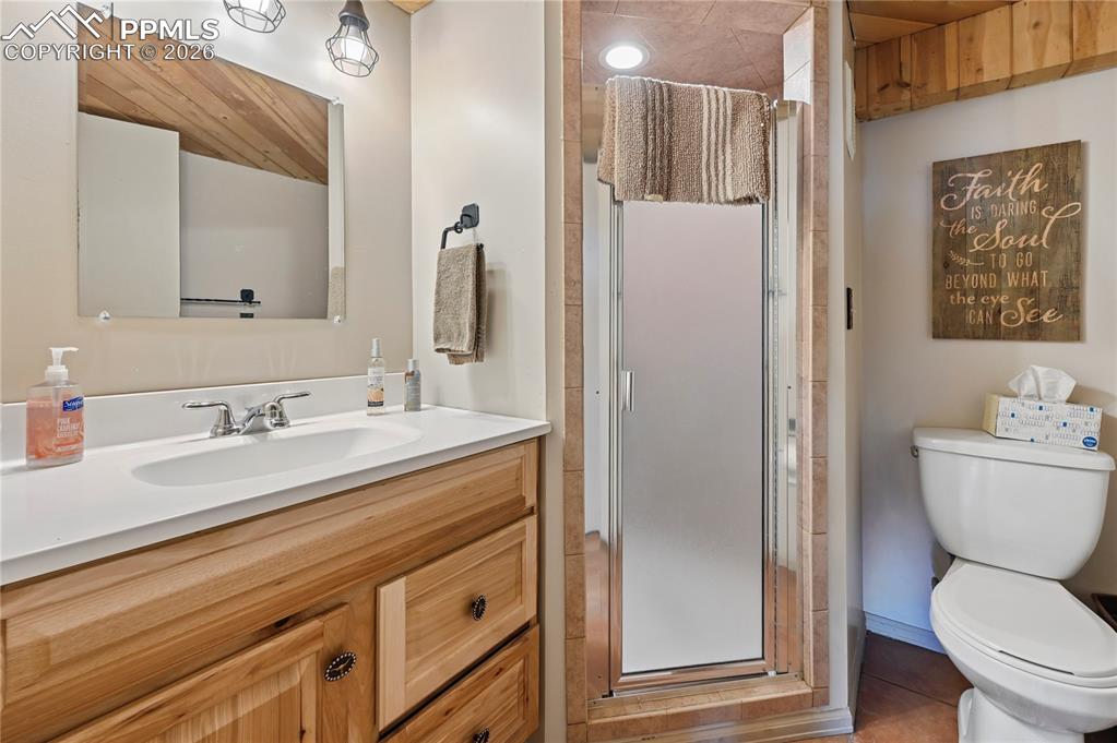 Image 36 of 43: The basement 3/4 bathroom is across from bedrooms #4 & #5. A hickory vanit
