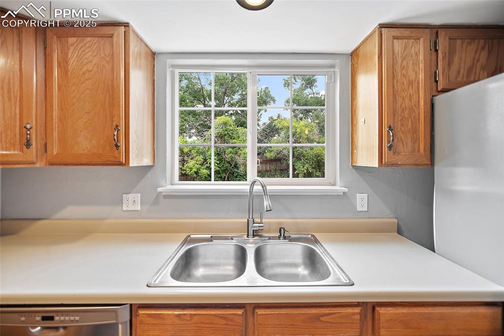 Image 15 of 50: kitchen window overlooks the backyard