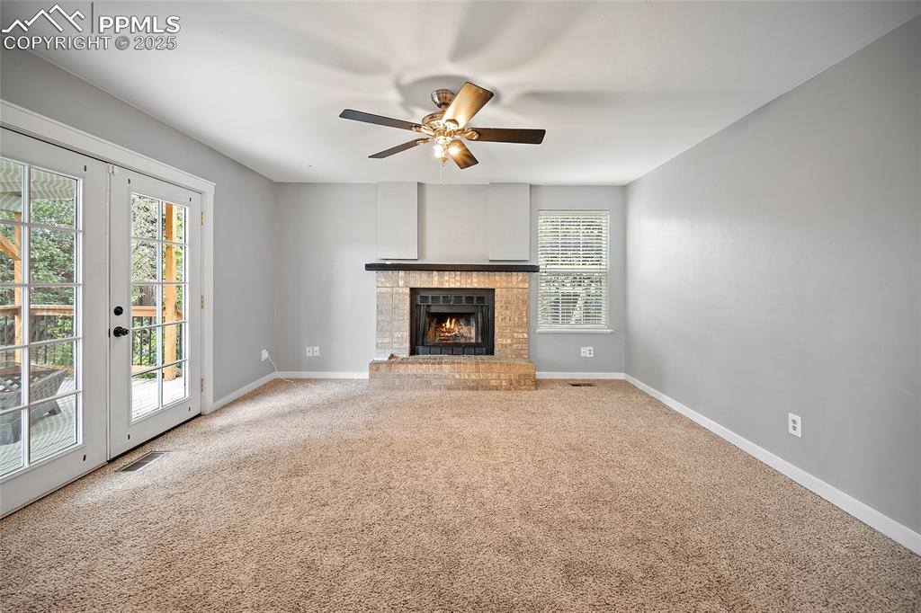 Image 17 of 50: family room with a wood burning fireplace