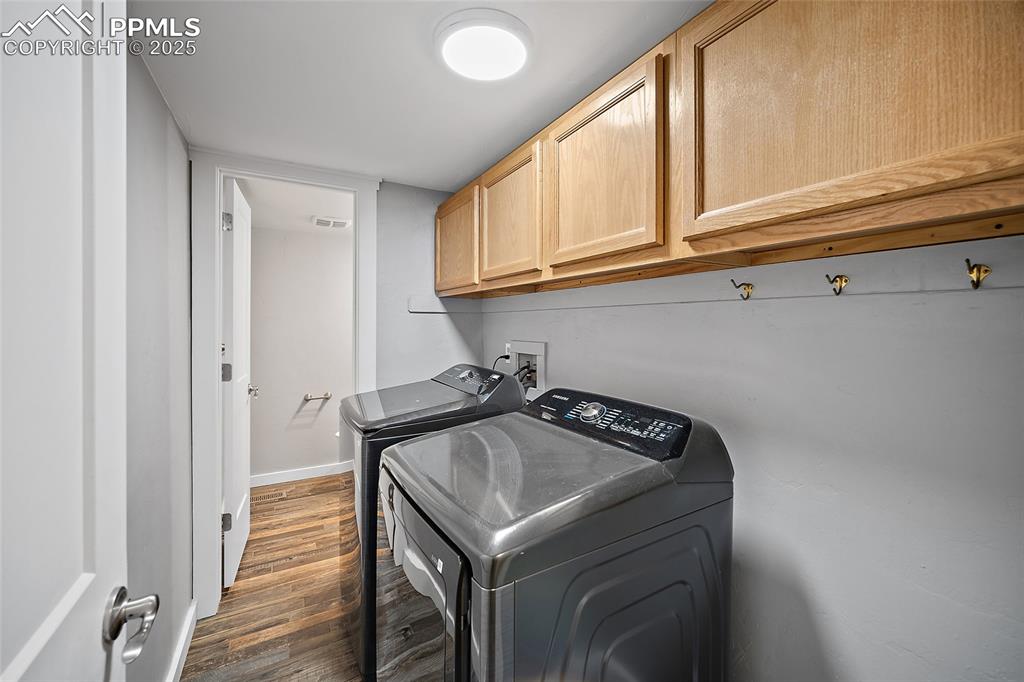 Image 20 of 50: laundry with a walkthrough to a 1/2 bath
