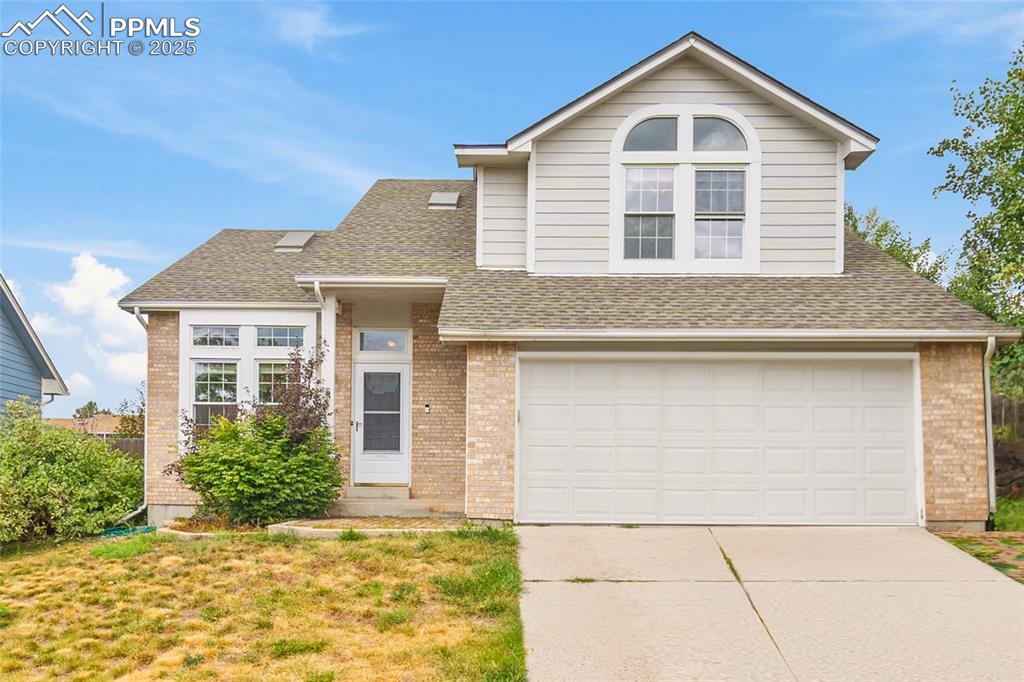 Image 44 of 50: front of the two-story home with a two car garage. (photo has been edited t