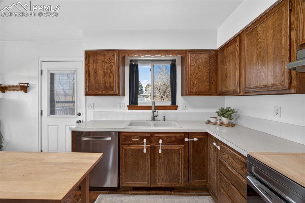 Image 10 of 34: Views of backyard from kitchen